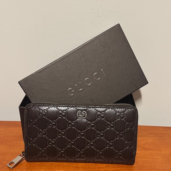 Gucci Handbags - Gucci Dark Brown Embossed Zip Wallet